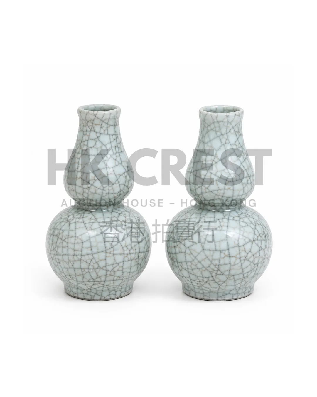 Pair of porcelain bottle vases with pale blue crackle-style glaze and understated…
