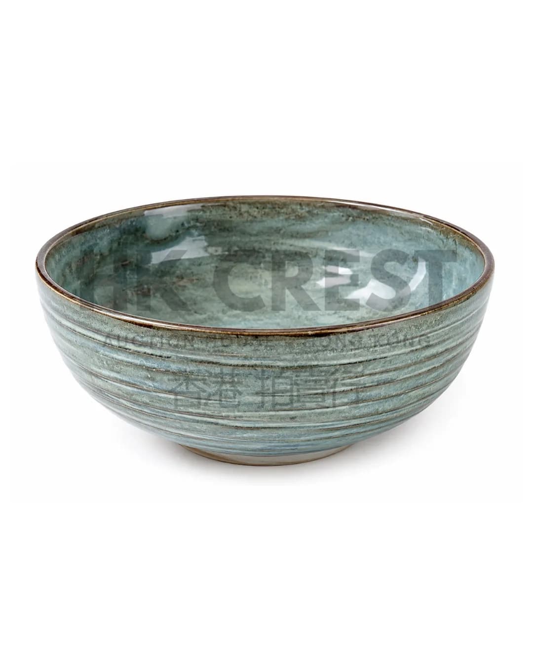 Hand-finished ceramic bowl with a wide low profile and translucent celadon-style glaze…