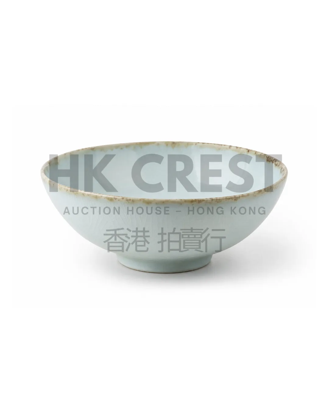 Shallow porcelain bowl with a pale celadon glaze, broad foot and subtly irregular rim