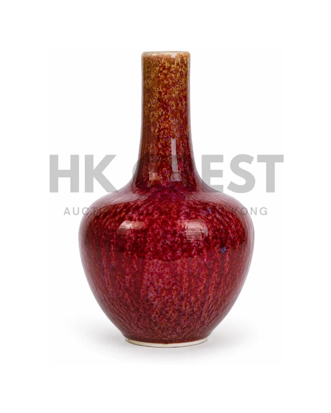 CHINESE BOTTLE VASE IS DECORATED WITH A DEEP TRANSMUTED GLAZE SHADING FROM CRIMSON TO…