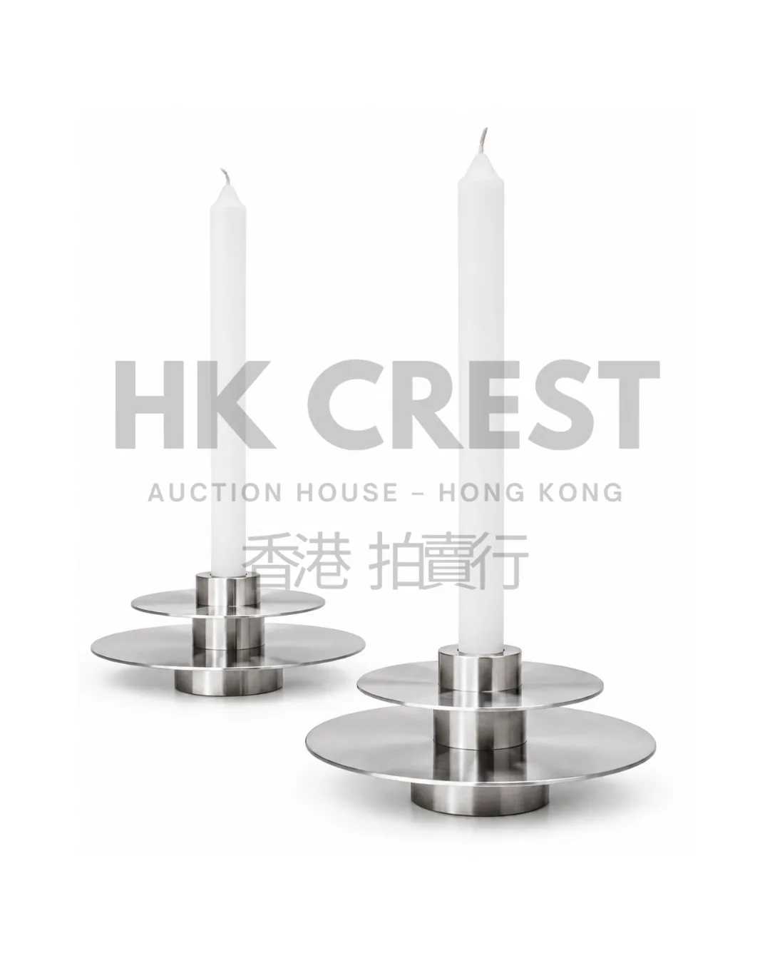 Pair of brushed stainless-steel candleholders with stacked geometric forms and weighted…