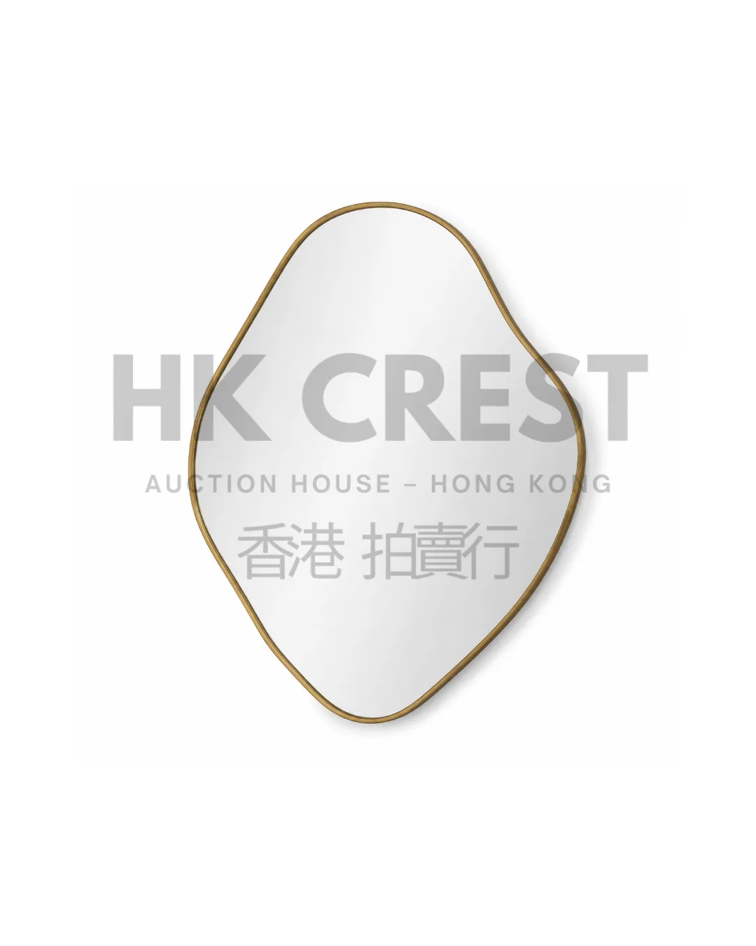 Irregular pebble-shaped wall mirror with a thin brushed brass frame and gently…